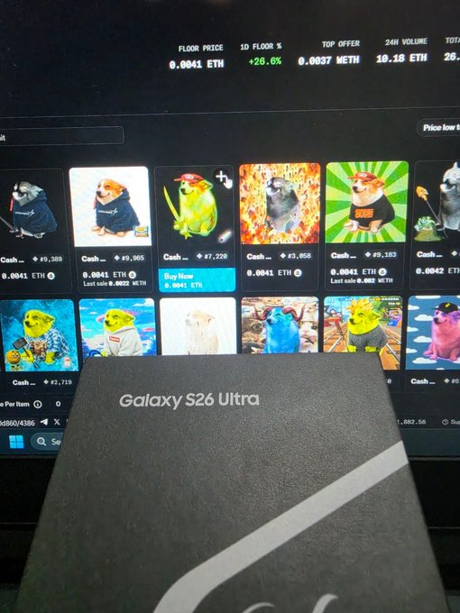 A Galaxy S26 Ultra box sits in the foreground while a monitor behind it displays an NFT marketplace showing various meme coin animal listings with floor prices around 0.0041 ETH, highlighting the modest current valuation that the caption "Wen $50 floor?" references as a hopeful price target.