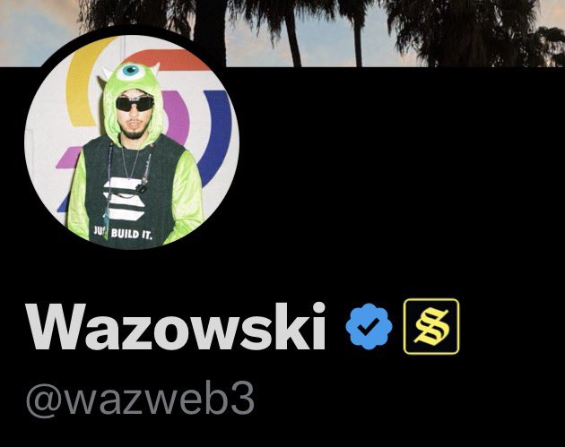A social media profile for 'Wazowski' (@wazweb3) featuring an avatar of a person in a green Mike Wazowski (Monsters Inc.) costume over a striped shirt, with verified and crypto badges next to the name.