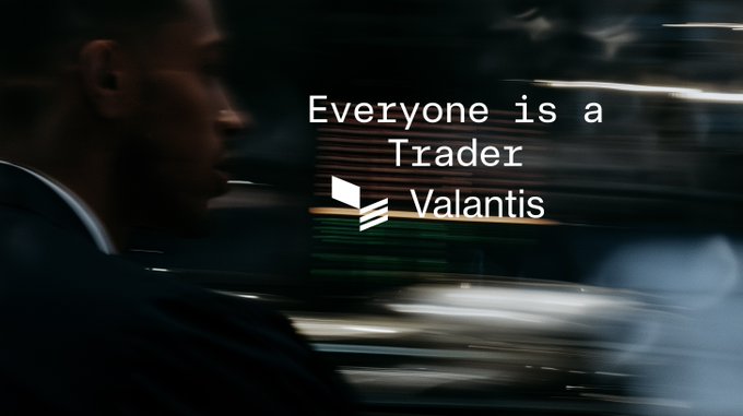 A motion-blurred promotional image showing a man in a suit walking past trading screens, with the text 'Everyone is a Trader' and a logo for 'Valantis'.