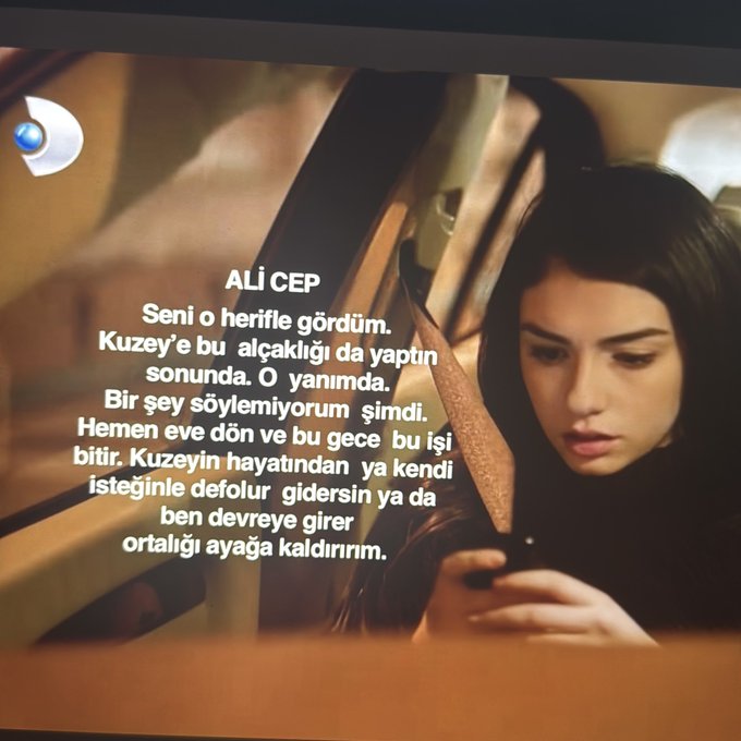 A subtitle screen from a TV show with Turkish text from a character named 'ALİ CEP' over a scene of a woman looking at her phone.