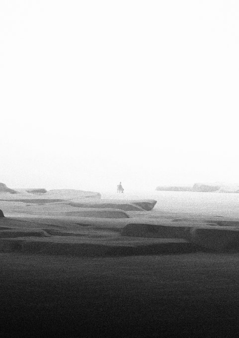 The image shows a lone figure standing on a misty, icy landscape under a vast pale sky.

Caption: A solitary figure stands on a misty, frozen landscape, evoking quiet solitude and contemplation—mirroring the haunting, atmospheric mood of the artwork featured in the post.