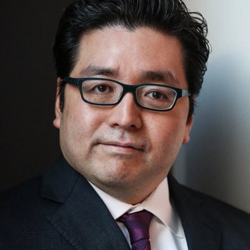 Tom Lee's Fundrise, the asset management firm where he serves as head of research, has purchased an additional 27,562 ETH worth $74 million, bringing BitMine's total holdings to nearly 6 million ETH at an average price of $2,688 per coin.

The image shows a close-up portrait of Tom Lee, a bespectacled man in a dark suit with a purple patterned tie, who is associated with the notable Ethereum acquisition news.