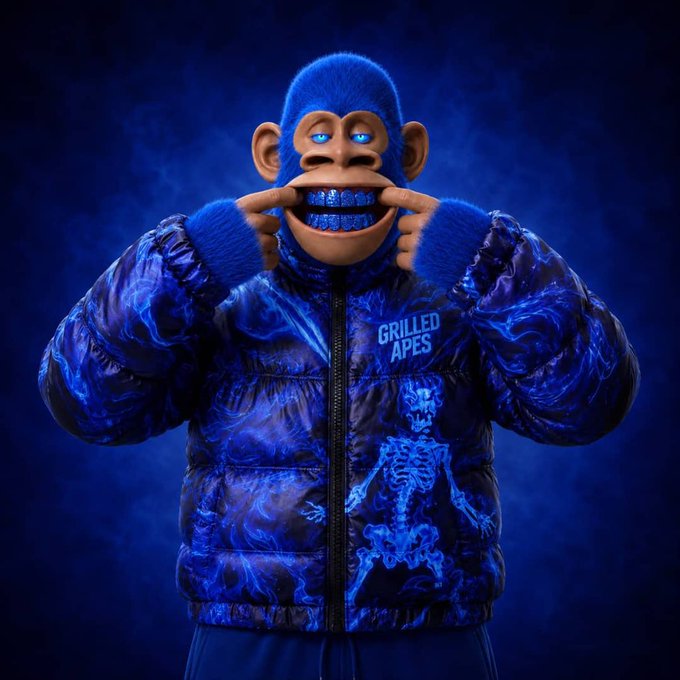 A 3D-rendered blue monkey character wearing a blue flame-patterned puffer jacket with a skeleton design and "GRILLED APES" text, pulling at its mouth to show teeth.
