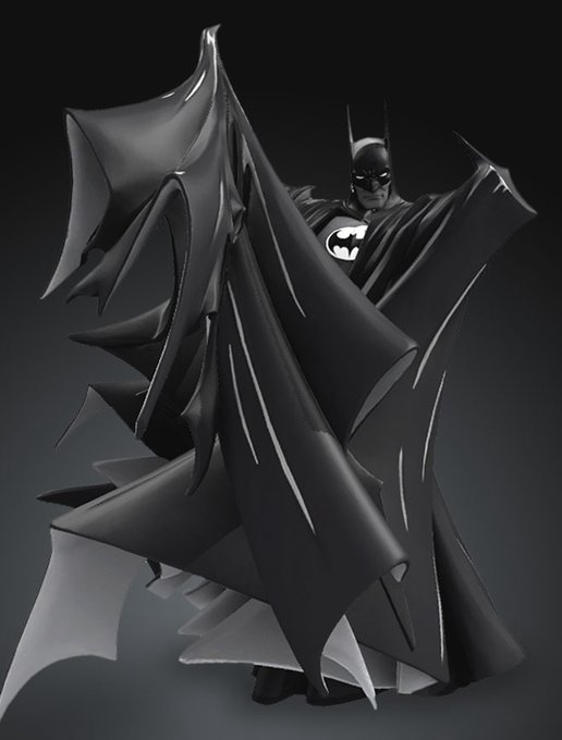 A dramatic black-and-white photograph of a Batman statue with his iconic cape spread wide, showcased in dark tones against a black background.