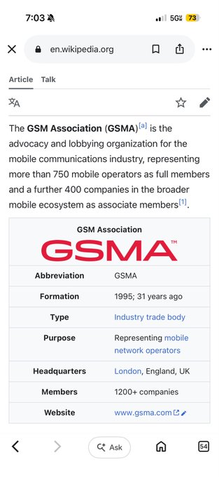 The image shows a screenshot of a website's homepage displayed on a phone screen with a search bar at the bottom of the page. The title "GSMA" is visible, along with an @telcoin link that appears to be a question or request for information about the GSMA and its purpose in developing stablecoin infrastructure.