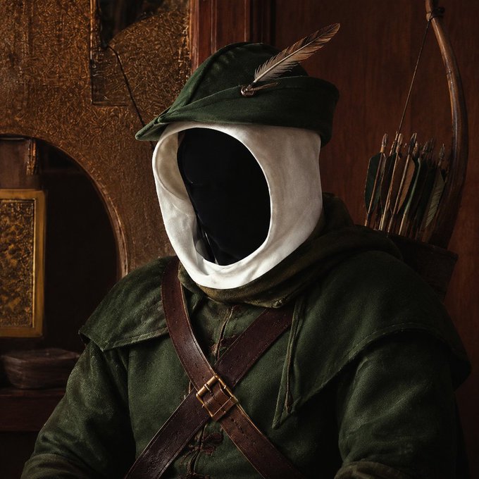 A figure in a green Robin Hood-style outfit with a feathered hat and a quiver of arrows on their back sits with their face completely obscured in shadow.