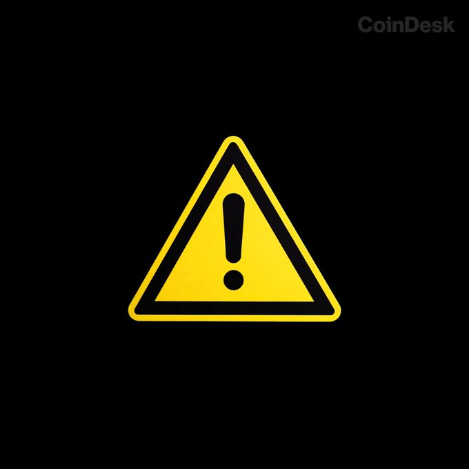 A yellow warning sign with an exclamation point is displayed on a black background, along with the "CoinDesk" logo. This image visually reinforces the message that Vault's design prevents attacks by using smart contracts and multisig protection for protocol operations, eliminating single points of failure.