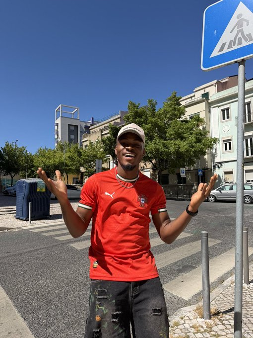 A man wearing a red Puma shirt with a crest logo smiles with arms outstretched on a sunny urban street, embodying the welcoming "Bro to Bro" invitation to greet and connect with 750 mutuals on X.