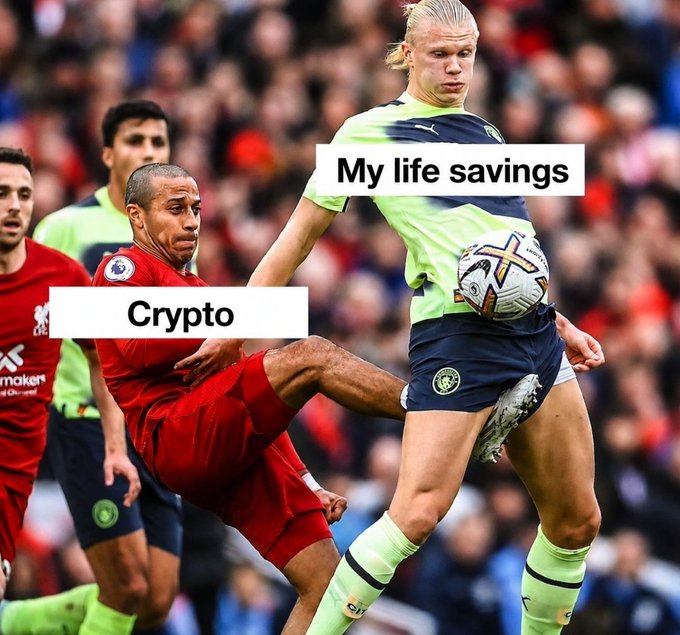A meme superimposed on a soccer match shows a player with "My life savings" over his chest and another player with "Crypto" on his shorts. The image humorously depicts the volatile nature of cryptocurrency investments.