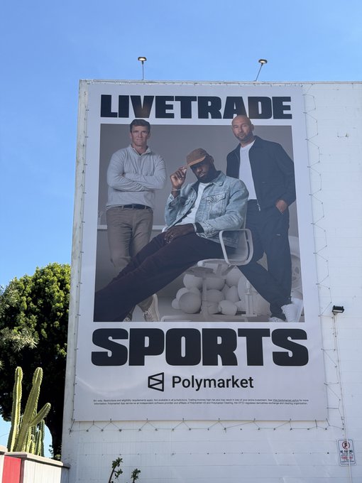 An outdoor billboard advertisement for 'LIVETRADE SPORTS' by Polymarket, featuring photos of three men in casual clothing.