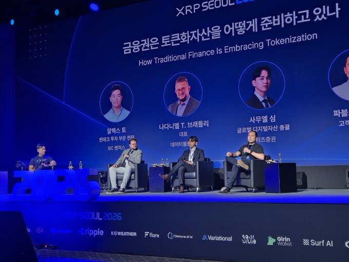 Four panelists sit on stage at XRP Seoul 2026 beneath a large screen displaying the discussion title "How Traditional Finance Is Embracing Tokenization" alongside headshots of speakers including speakers labeled from SC Ventures, a data firm, and Global Digital Asset totaling, illustrating the conference's focus on moving tokenization from concept to commercial deployment.