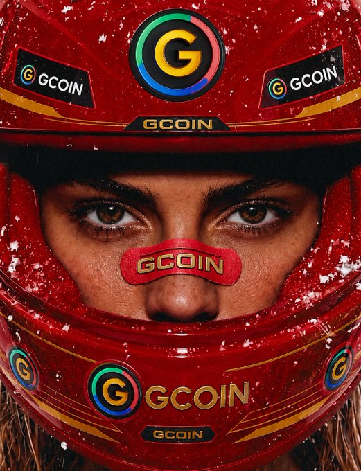 A close-up of a person wearing a bright red racing helmet heavily branded with the 'GCOIN' logo and a colorful 'G' symbol, with only their eyes visible through the visor.