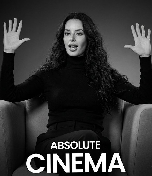 A black-and-white photo shows a woman with long, curly hair sitting in a chair with her hands raised and palms out in an exasperated expression, wearing a black turtleneck, with the text "ABSOLUTE CINEMA" displayed at the bottom.

The image humorously illustrates the post's point about panic-selling investors—the woman's wide-eyed, shocked "I can't believe this" pose and the "ABSOLUTE CINEMA" caption perfectly capture the absurdity of watching people sell low only to FOMO back in at higher prices.