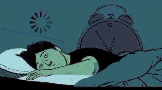 A person lies awake in bed under dim lighting with a clock showing the "12" position behind them, capturing the restless, sleep-deprived mood of someone staying up too late—fitting the weary, late-night farewell of "Gn guys."