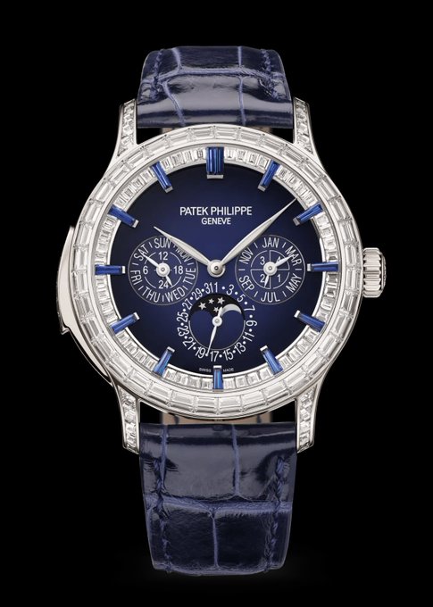 A luxurious Patek Philippe wristwatch with a blue dial featuring perpetual calendar subdials (day, date, month) and a moonphase complication, set in a diamond-encrusted case and paired with a navy alligator strap—befitting the eye-watering $3.25M price tag and the "if you know you know" exclusivity the post alludes to.