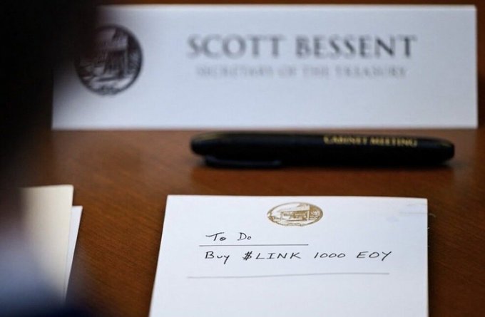 A handwritten to-do note reads "To Do: Buy $LINK 1000 EOY" sitting on a wooden desk alongside a pen and a business card for "Scott Bessent, Secretary of the Treasury," suggesting a connection between U.S. Treasury leadership and cryptocurrency investment recommendations.
