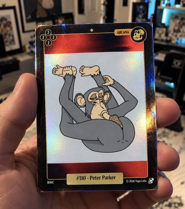 A hand holds a holographic Yugalabs trading card labeled “ARCANA,” “BAYC,” and “#110 - Peter Parker,” featuring a cartoon monkey.