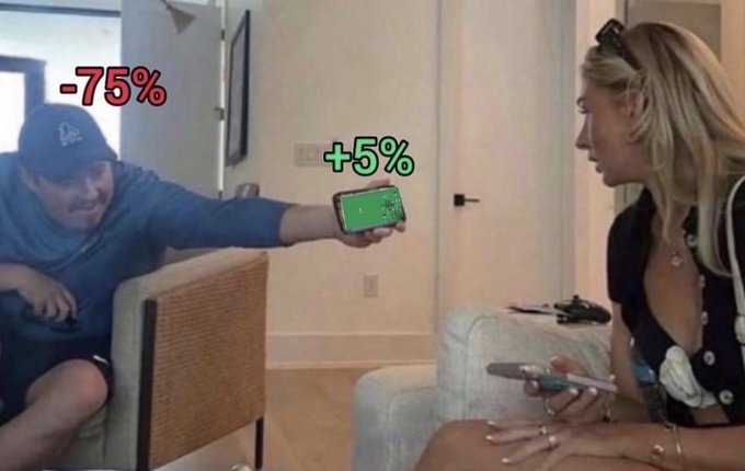 A meme image showing a man showing his phone to a woman with text overlays '-75%' above the man and '+5%' above the woman, referencing crypto/stock market losses versus gains.