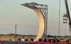 A SpaceX Starship test vehicle stands upright on a launch pad, with crowds gathered nearby to watch what the post claims is Tesla's newly announced "flying Roadster" in a dramatic vertical liftoff display.