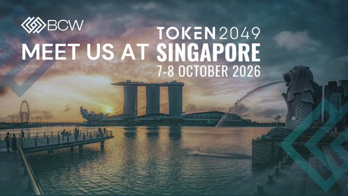 A promotional banner for BCW reading 'TOKEN2049 MEET US AT SINGAPORE 7-8 OCTOBER 2026' over an image of the Singapore skyline featuring the Merlion and Marina Bay Sands.