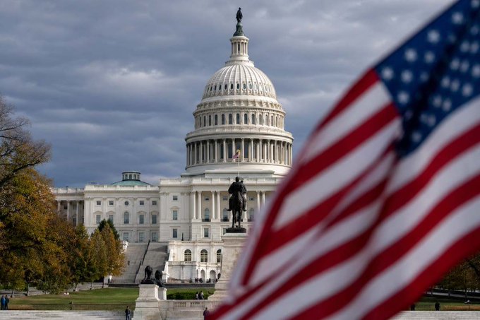 The image features a large American flag flying next to the United States Capitol building. The caption reads "banks fear competition A spokesperson for Senator Lummis says banks are spreading false claims about stablecoin legislation because they fear digital finance." This statement suggests that there is an ongoing debate or discussion regarding the potential impact of stablecoins on traditional banking institutions, with some people expressing concerns and fears about their influence.

The image also includes a statue of a man riding a horse in front of the Capitol building, which adds to the overall atmosphere and significance of the scene. The combination of these elements creates an interesting juxtaposition between the historical and political context of the American flag and the modern-day concerns surrounding stablecoins.