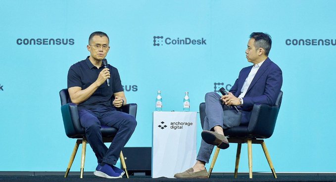 At the CoinDesk Consensus 2025 conference, Changpeng Zhao (CZ) shares his perspective on the U.S. potentially becoming the "capital of crypto" if regulatory clarity improves, highlighting how the industry is evolving beyond technology into a broader competitive race.

The image shows CZ in a dark polo shirt being interviewed on stage by a moderator in a suit, with visible branding for Consensus, CoinDesk, and Anchorage Digital against a teal backdrop.