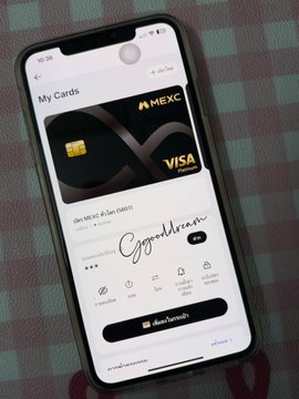 A smartphone displays the Bank of America mobile app showing a 'My Cards' section with a black MEXC Visa card featured prominently.