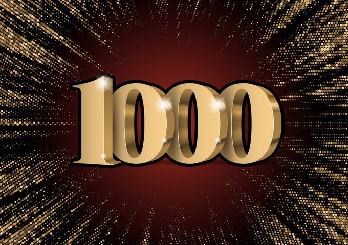 A decorative graphic displaying the number 1000 in gold 3D lettering against a sparkling red background.