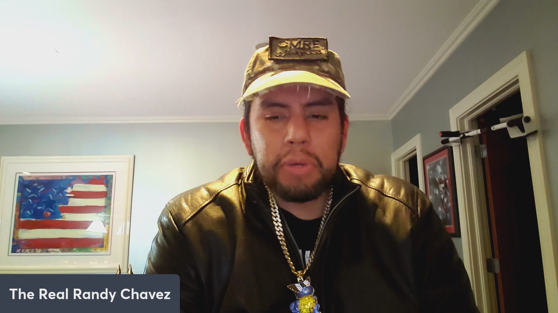 The image features a man wearing a hat and jacket, possibly a baseball cap due to its shape and size. He has facial hair - either a beard or goatee - and he's sitting in front of a door with his mouth closed. The caption provided below states that the image is from "Chavez podcast #306". The post mentions the radio show host has discussed market talk, possibly on topics related to the automobile industry, as suggested by the "Automobile" category.