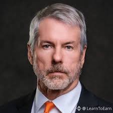 A professional headshot of a bearded man in a suit and orange tie is shown, with the watermark "@LearnToEarn" visible in the corner. The image likely represents a commentator discussing Strategy's sale of 3,588 BTC ($225M), a notable event given the company's longtime advocacy for holding Bitcoin.