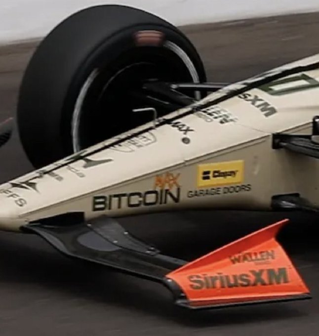 urn of a race car, with "Wallen SiriusXM" and "Bits" on the side, is tilted to the left against a gray background.