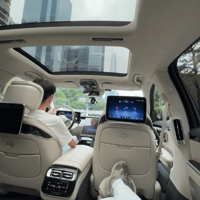 The image shows the luxurious interior of a high-end vehicle, likely a Mercedes-Maybach, featuring a panoramic sunroof, dual rear-seat entertainment screens, and a driver at the wheel, with a passenger relaxing their feet on a reclined seat. This opulent setting visually embodies the "200K to 58M" crypto success story, symbolizing the lavish lifestyle achievable through disciplined trading strategies.