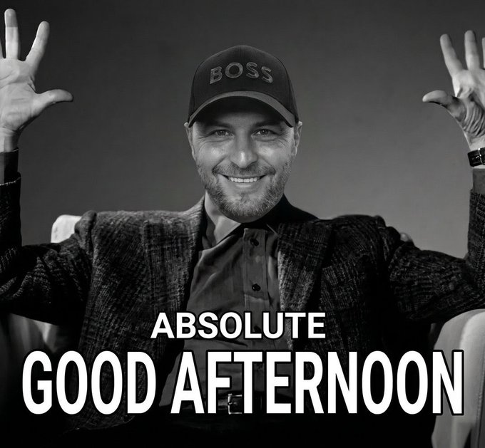 The image features a man wearing a black hat, sitting comfortably with his arms raised up in the air. The caption below him reads "Good Afternoon All Tria Fam Have a absolute Good Afternoon", which seems to be a reference to the app they are using or talking about. This post is likely promoting an app that helps people remember their tasks and appointments by associating them with specific times, like Good Afternoon.