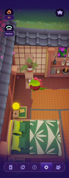 A screenshot from a mobile game showing a green frog-like character standing in a traditional-style room with tatami flooring, a bed, and various decorative items, with score indicators showing '84', '100', and 'Perfect' at the top.