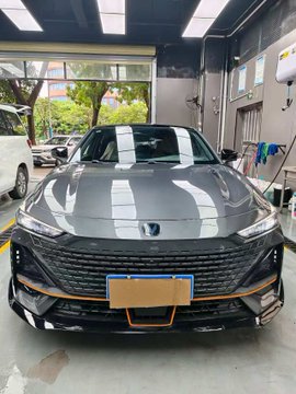 A sleek black Changan sedan, likely a Changan UNI-V, is displayed in a dealership showroom with its front grille and Changan emblem prominently visible. The post's reference to "PR" suggests a playful jab at marketing hype, implying the car's bold, aggressive styling and premium appearance might be all presentation rather than reflecting the actual asking price.