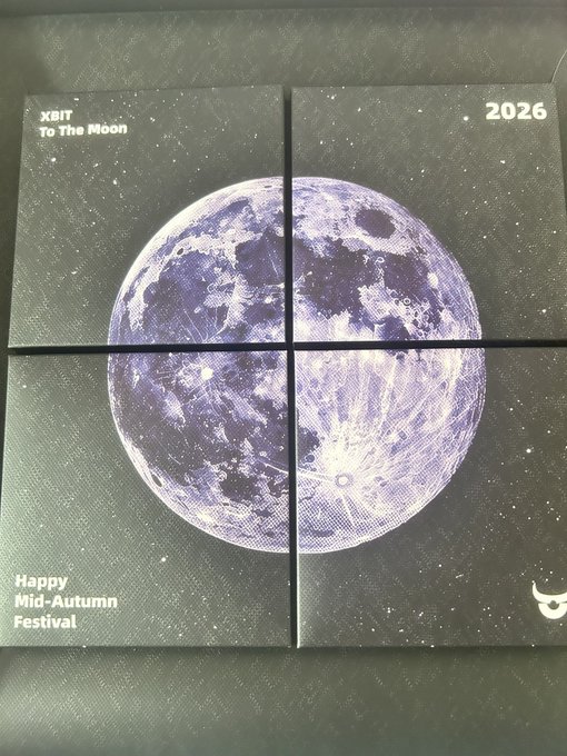 A four-piece black gift box features a large purple-toned moon against a starry background, with text reading "XBIT To The Moon," "2026," "Happy Mid-Autumn Festival," and a Taurus zodiac symbol—reflecting the post's celebration of XBIT receiving a Mid-Autumn Festival mooncake gift box for moon-gazing.