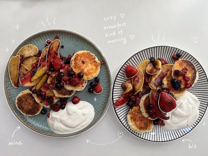 Two plates of cottage cheese pancakes topped with mixed berries and a dollop of yogurt or sour cream sit side by side, labeled "mine" and "his" in handwritten text, with the playful note "cozy ♡ breakfast kind of morning" above—visually bringing to life the post's cozy, protein-packed morning vibe with a touch of meme-worthy charm.