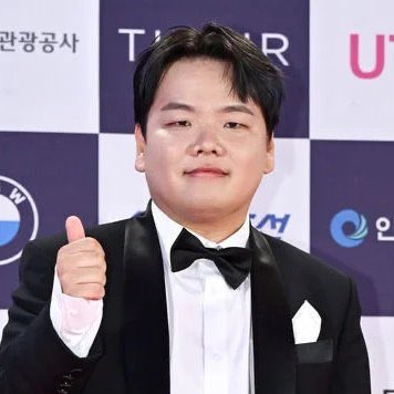 The image shows a man dressed in a tuxedo, giving a thumbs up gesture with his left hand while wearing a bow tie. The background features a checkerboard pattern of logos, including one for Bmw and another for Humanity Foundation. The text on the image reads "This is one of the biggest crypto collapses of 2026 Here's what happened: Humanity Protocol suffered a major security incident. The team says private keys belonging to a Humanity Foundation member were compromised. Meanwhile the market started panicking."