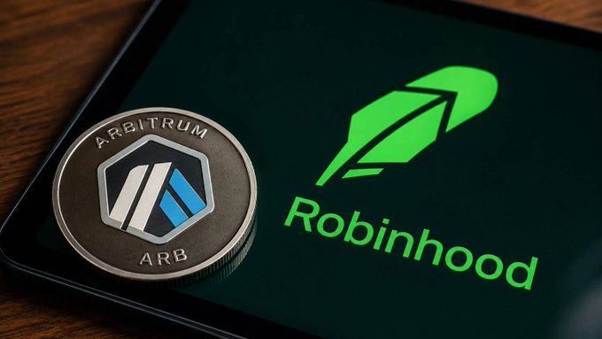 A physical Arbitrum (ARB) coin rests on a smartphone screen displaying the green Robinhood logo, visually representing the context in which the Solana Foundation advised Robinhood's blockchain project to abandon the Arbitrum L2 framework in favor of building its own high-performance chain.