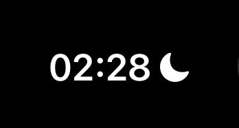 Digital clock display showing '02:28' with a moon icon indicating night mode on a black background.