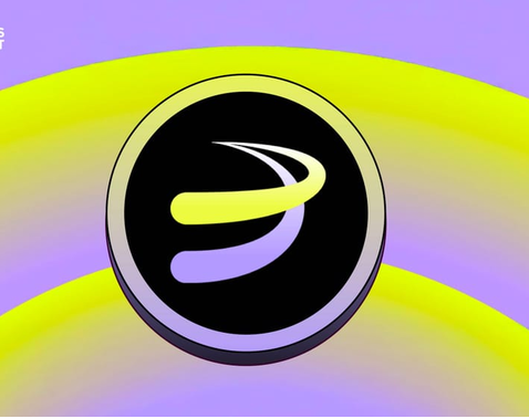 A circular black logo with a stylized green and purple 'S' or swirl design, set against a gradient yellow and purple background.