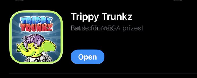 The image displays a promotional banner for the mobile game "Trippy Trunkz" featuring a cartoon elephant character in a spacesuit, with an "Open" button to launch the game. It relates to the post by showcasing the game's interface, likely as part of an announcement about an upcoming game update that players will need to download to remain eligible for leaderboard rewards.