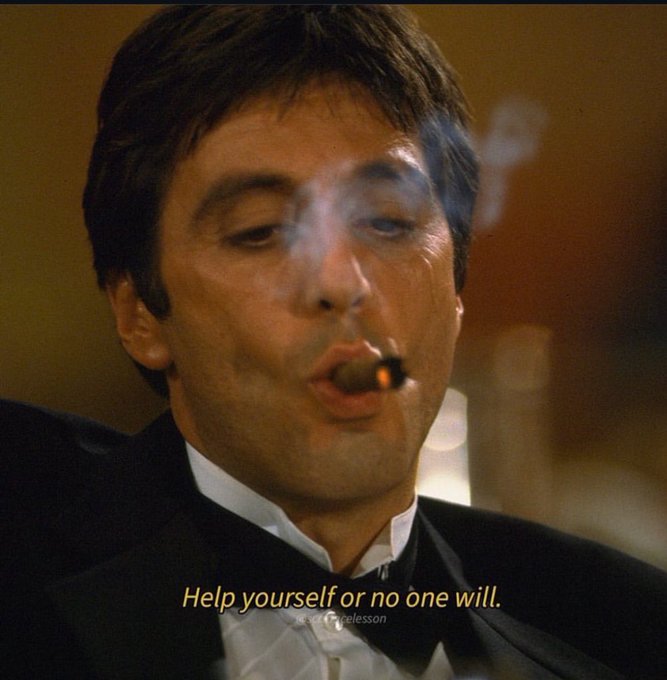 Screenshot from a film showing a man in a tuxedo smoking a cigar, with yellow subtitle text reading 'Help yourself or no one will.'