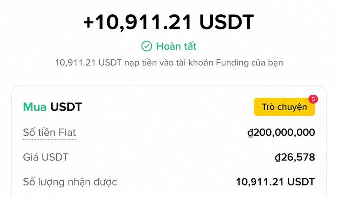 The image shows a completed USDT purchase confirmation of +10,911.21 USDT, where a user paid 200,000,000 đ (VND) at a rate of 26,578 đ per USDT. This visually supports the post's message about proactively buying USDT in advance to prepare for a potential market dip before July 1st, as Vietnam's legal framework evolves.