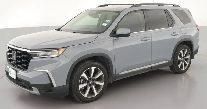 A light gray Honda SUV photographed in a studio setting.