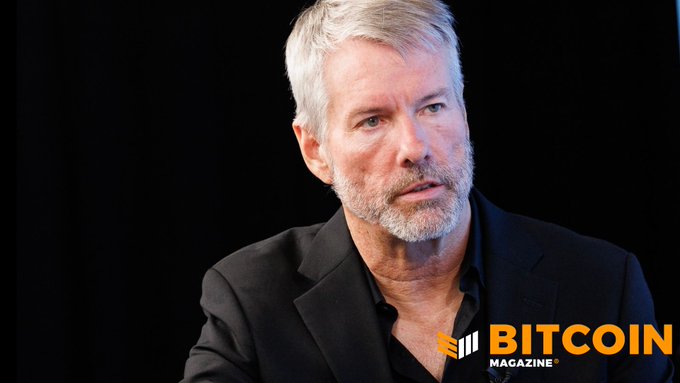 A portrait of a gray-haired man with a beard wearing a black shirt and blazer, with the 'BITCOIN MAGAZINE' logo in the bottom right corner against a dark background.