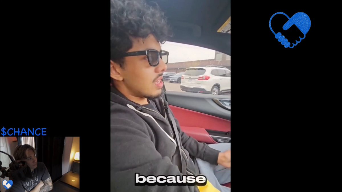 The image shows a man wearing glasses driving a car with the words "becauses" written on his shirt. The background features a car and a parking lot, suggesting that they are at an intersection or a busy street. There is also a blue heart icon in the top right corner of the image.