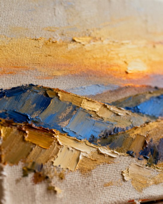 The image features a painting of a sunset over a mountain range, with warm colors such as orange, yellow, and blue used for the sky and mountains respectively. The artist has applied thick brushstrokes that create texture and depth in the artwork. The painting is displayed on canvas or paper, which can be seen in various sizes and orientations across the image. The post includes a photo of the painting with a caption about the artist's technique, likely discussing how they used the brushstrokes to convey the warm colors and textures of the sunset over the mountains.