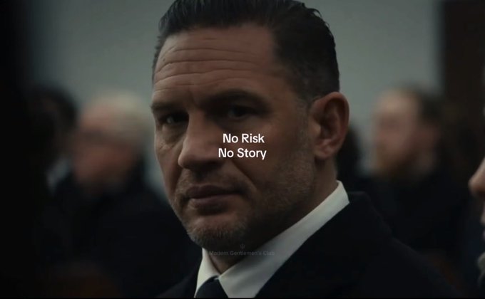 A still from a film shows actor Tom Hardy in a suit with the overlaid text 'No Risk / No Story' and a subtitle reading 'Roberts Gentleman's Club'.