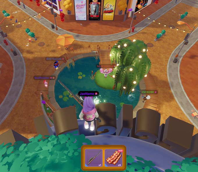 A screenshot from a video game showing cartoon-style avatars in a colorful town square with a pond, lily pads, and movie posters in the background; usernames like 'Buy1eoon', 'JoeName', and 'SSC828R' are visible above the characters.